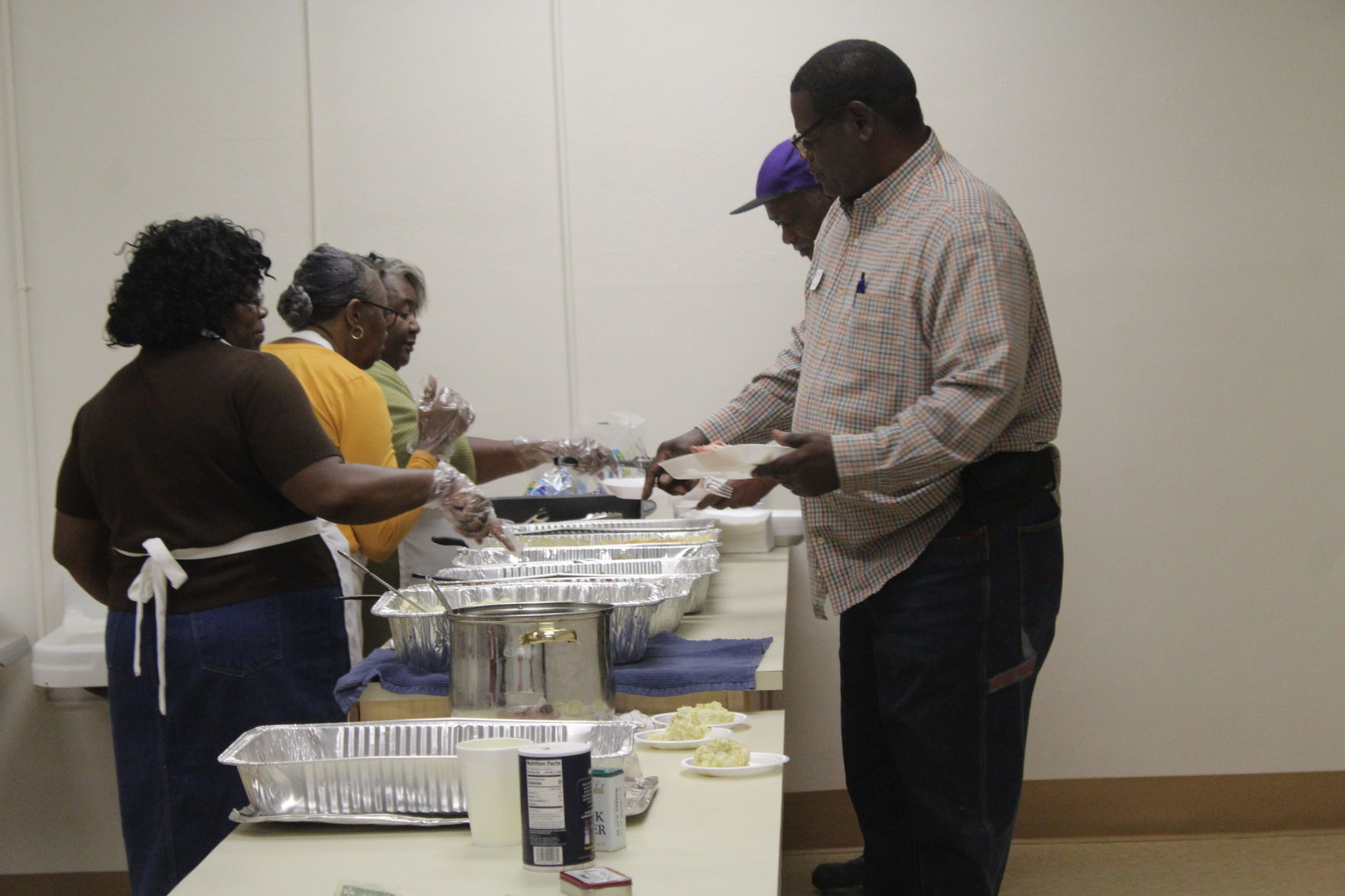 Volunteers serve meal